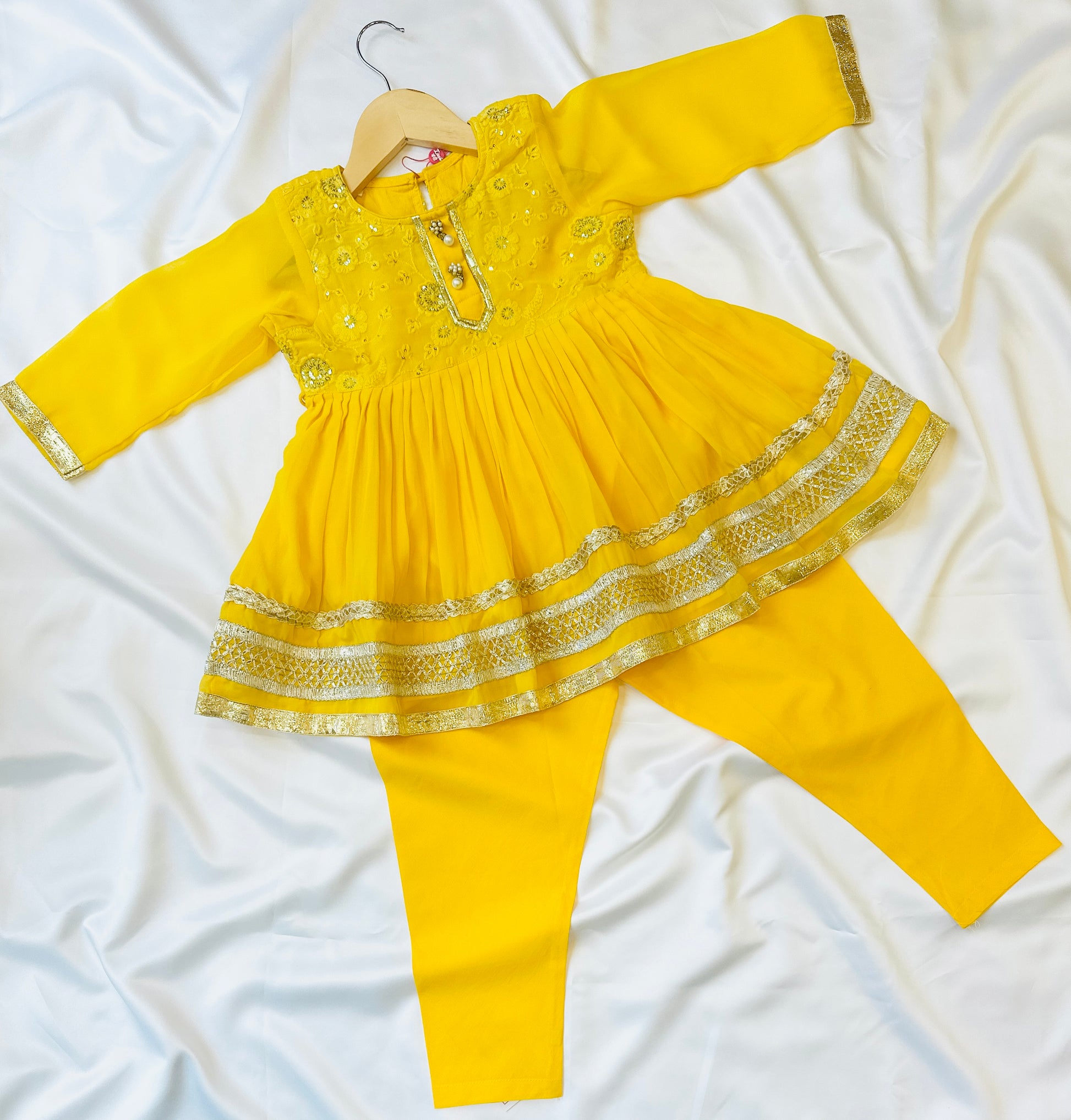 Girls Indian tradtional dress in yellow with heavy lace work.